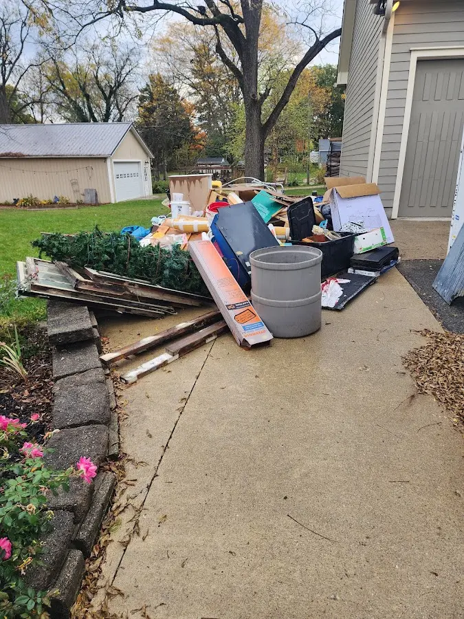 Dumpster being loaded with debris for Commercial Dumpster Rental in Williams